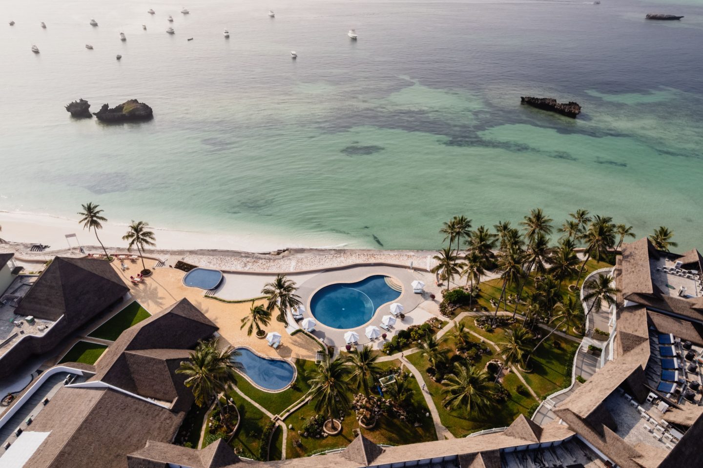 A coastal property with pools running down toward the shoreline