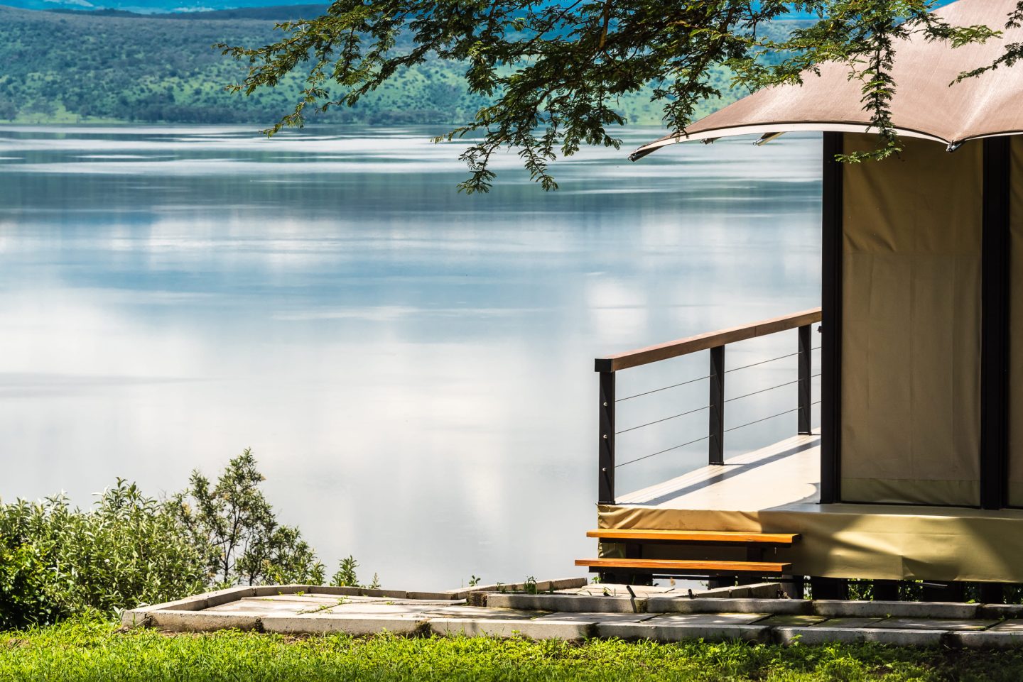 A freestanding tub on a timber deck looking out over open water