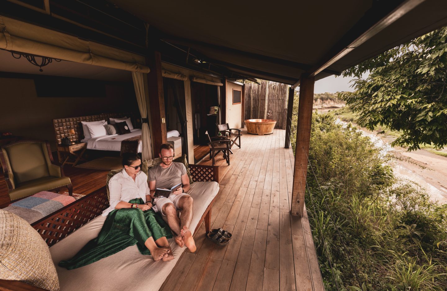 Guests resting on a shaded tented deck in the afternoon