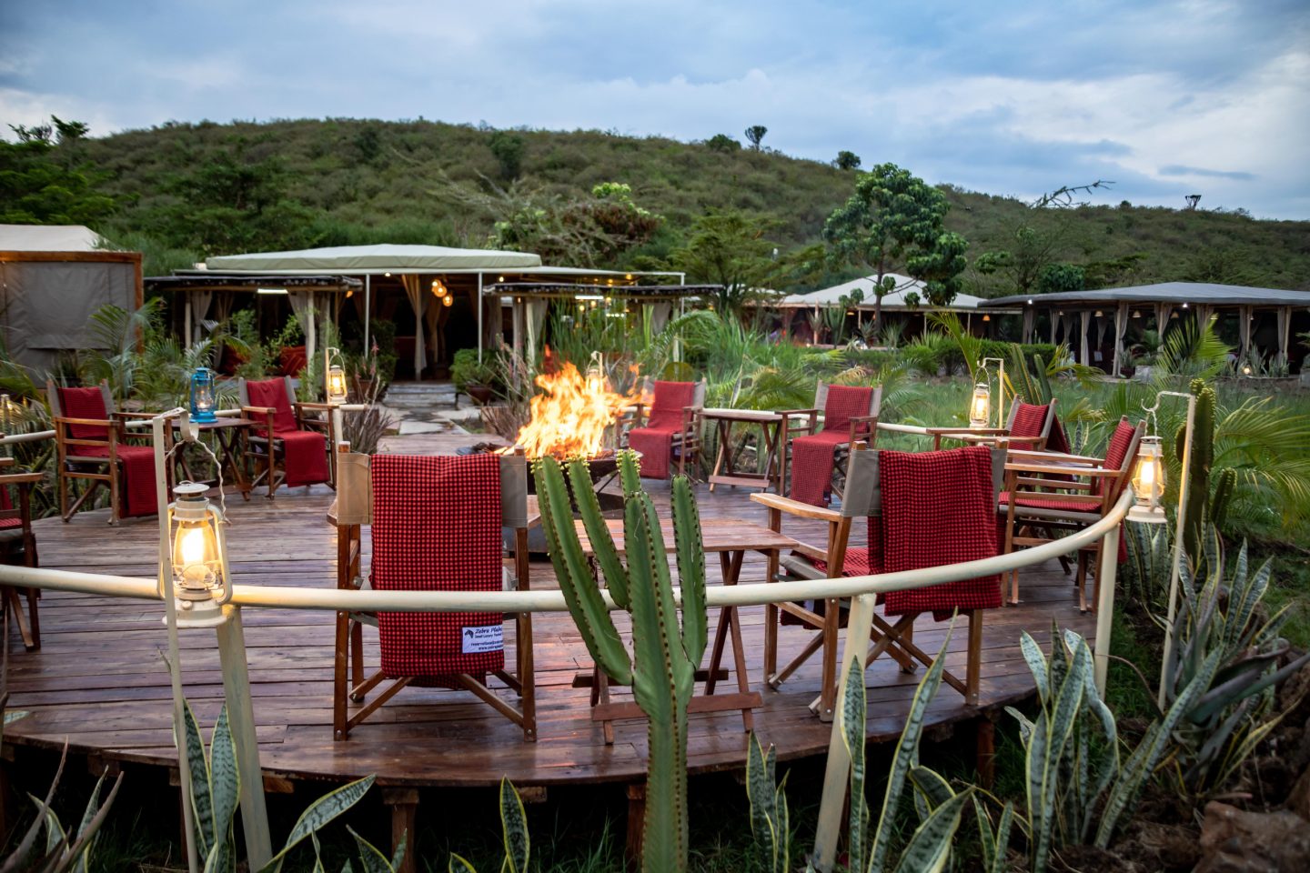 Lounge seating beside a fire, looking out over rolling hills