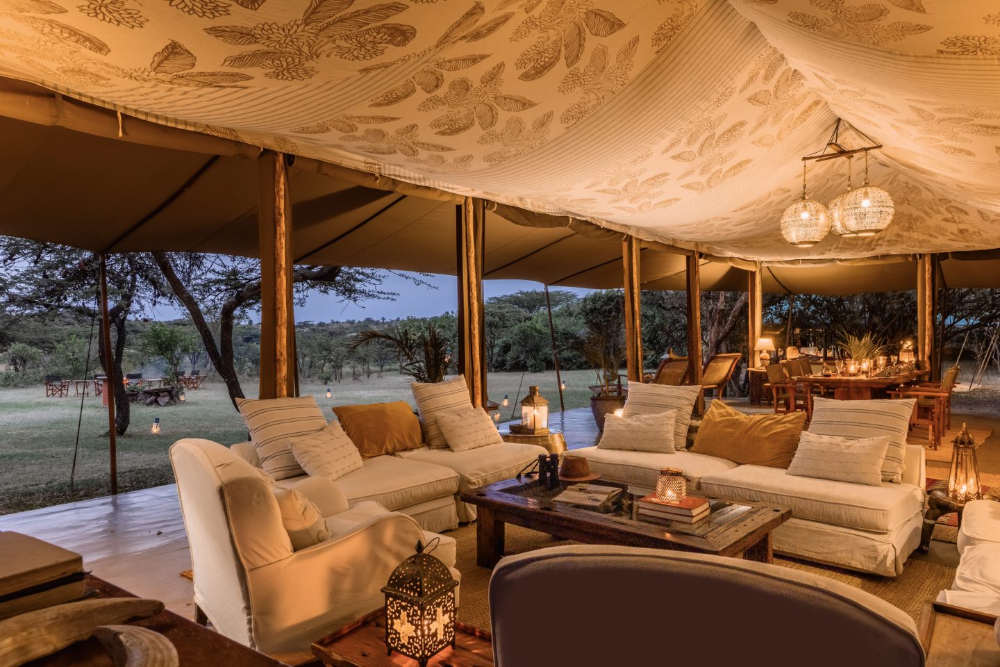 The lounge of a mess tent with sofas under a canvas roof