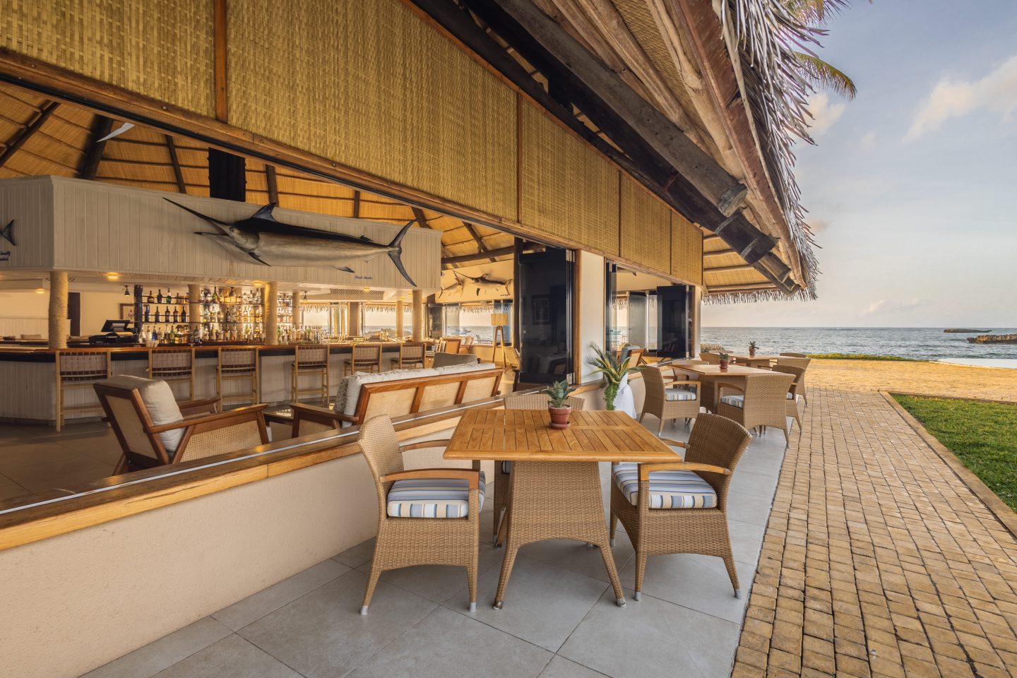 An open-sided bar with stools along a timber deck