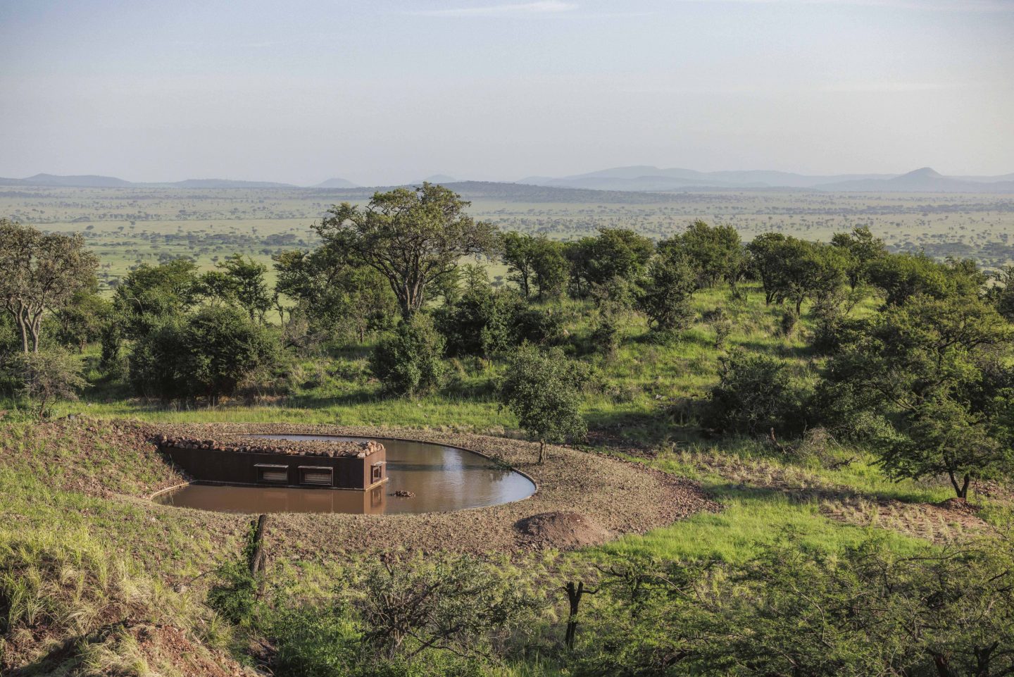 Green country seen from the opening of a low photographic hide